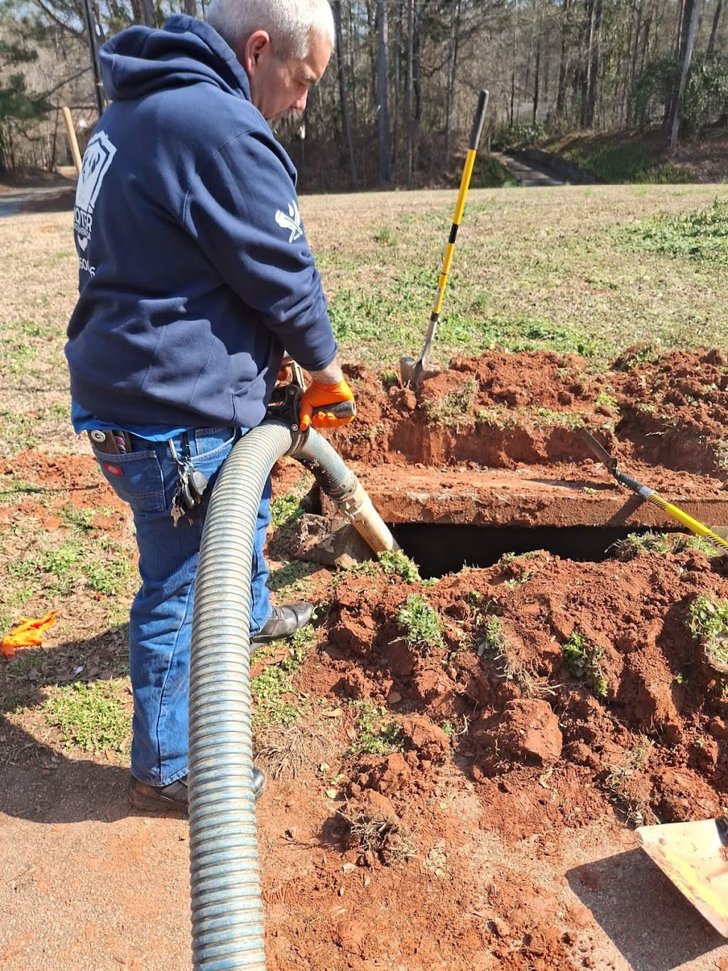 Rooter Pro technician performing outdoor sewer line excavation and service